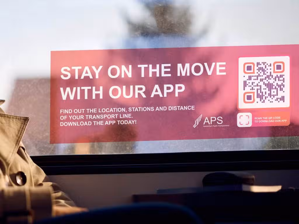 a qr code on a window with a red sign saying to download their app