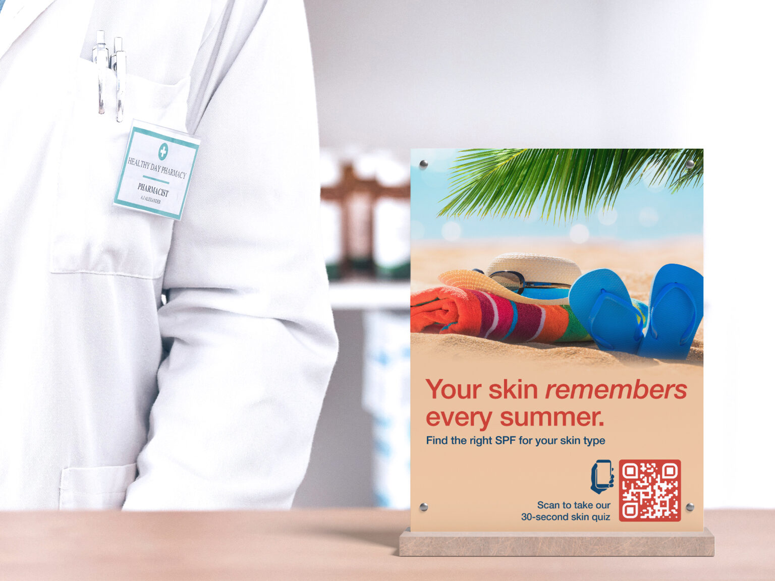 a pharmacist standing next to a table tent for sunblock with a qr code on it and the beach on the picture