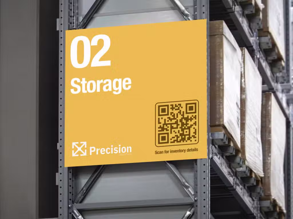 A yellow sign with a QR code on the side of a pallet rack.