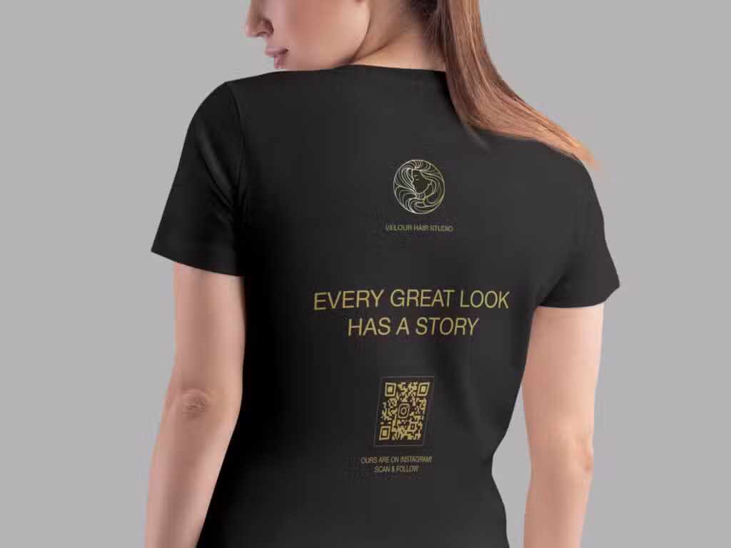 instagram qr code for a salon on the back of a black t-shirt that a lady is wearing